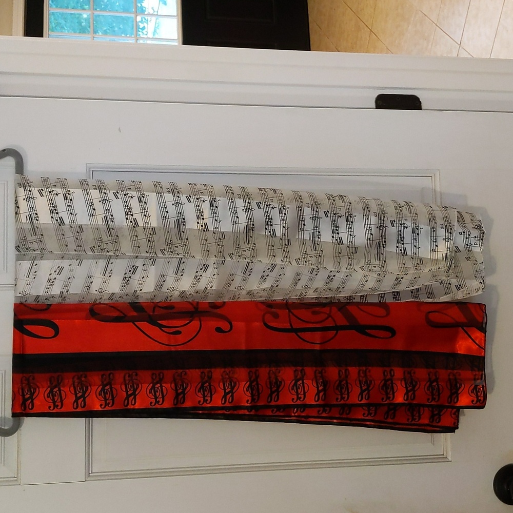 Ladies sheer musical note scarves, one red, one cream, with black notes